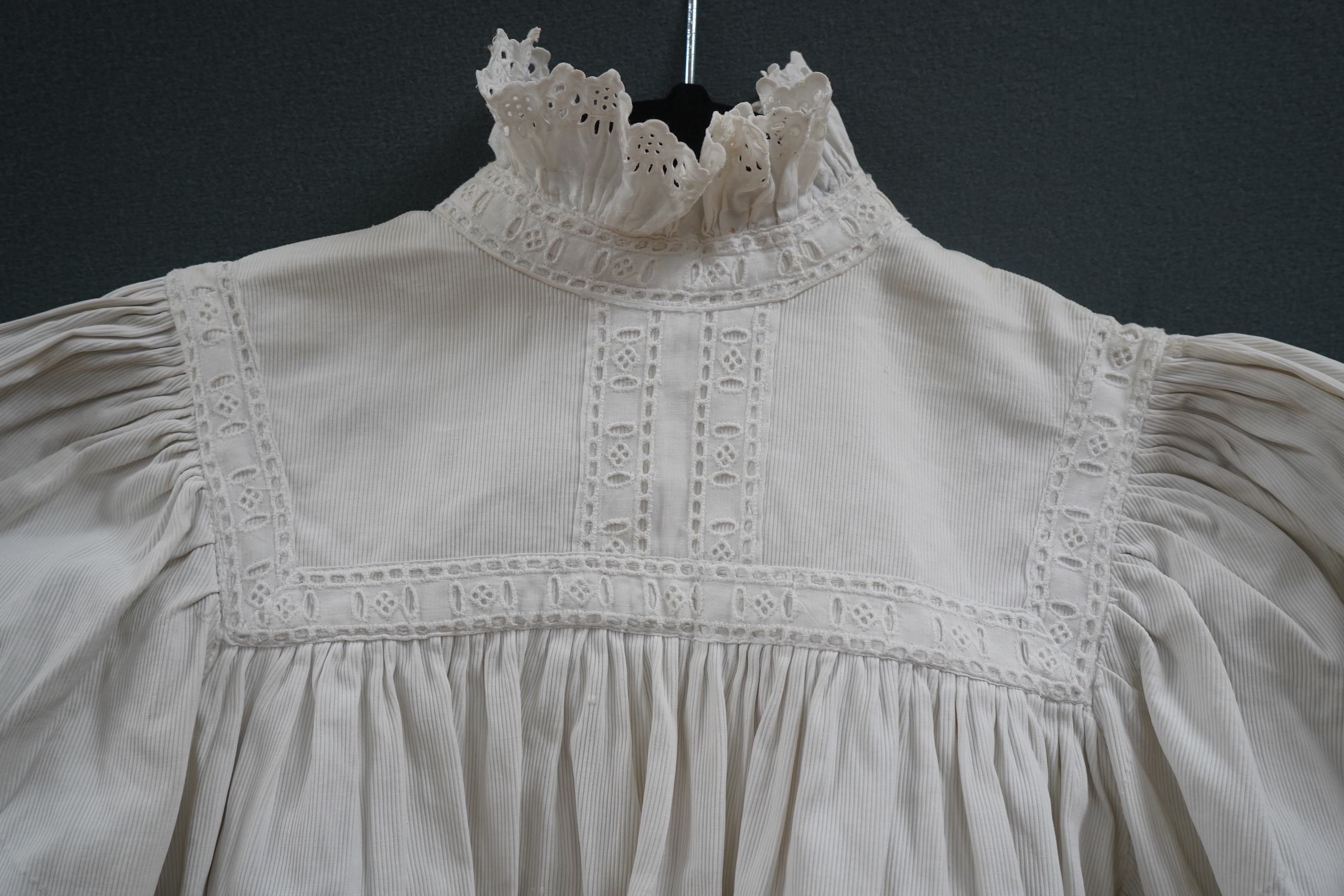 Two late 19th early 20th century girls summer dresses, one fine cotton with white worked collar cuffs and bodice, the other a cotton twill with anglaise collar large puff sleeves and gathered across the chest, lawn dress